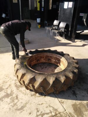 Skilled technician performing a tyre fitment.