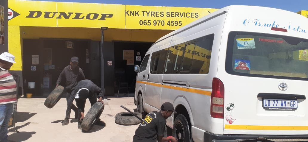 Skilled technician performing a tyre fitment 1